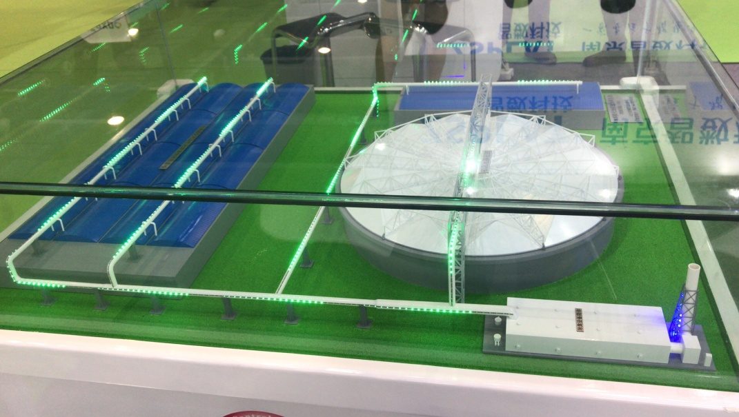 Water treatment plant model with green-lit basins